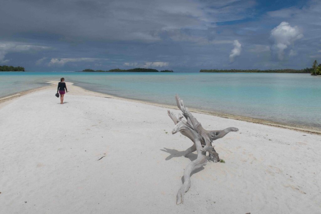 strolling on a white sand beach in Rangiroa, French Polynesia